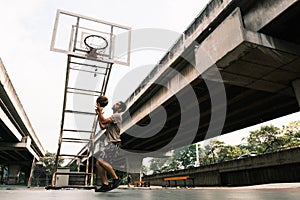 Two caucasian men pratice baskegball in court at urban street