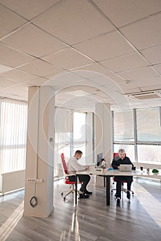Two Caucasian men working in an office.
