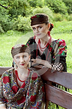 Two caucasian slavonic women sitting on the bench