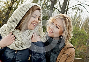 Two caucasian smiling woman in autumn outdoors