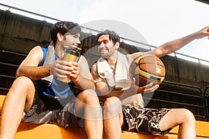 Two causian basketball player resting and ralax
