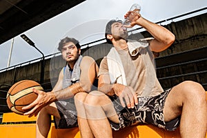 Two causian basketball player resting and ralax