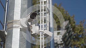 Two CCTV cameras on park pole. remote security surveillance system. area. control of order by security authorities.