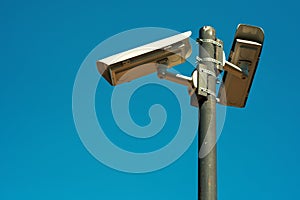 Two CCTV security cameras mounted on high post