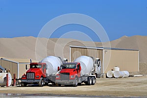 Two cement mixer trucks