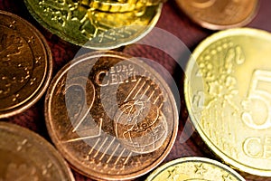 Two cents on the background of other coins Euro cents macro photo