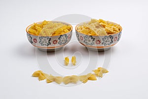 Two ceramic bowls full of pasta make up a smiling face