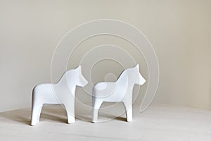 Two ceramic horse figurines stand on a table