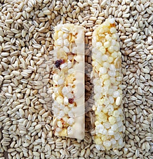 two cereal bars covered with wheat seeds