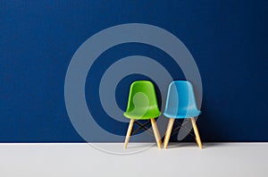 Two chairs against a blue wall. Business Concept