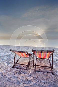 Two chairs beach and sunset