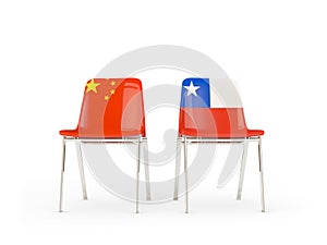 Two chairs with flags of China and chile