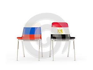 Two chairs with flags of Russia and egypt isolated on white