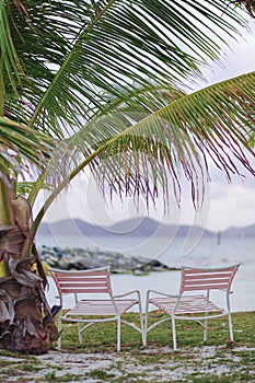 Two chairs by the ocean.