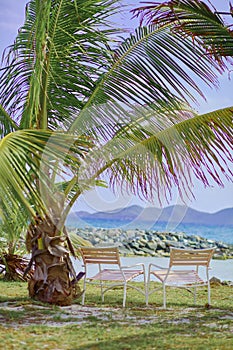 Two chairs by the ocean.