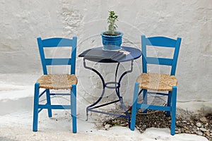 Two chairs outside a Greek restaurant