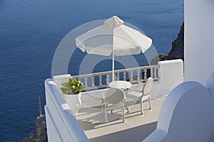 Two chairs with the sea view. Oia, Santorini, Greece.