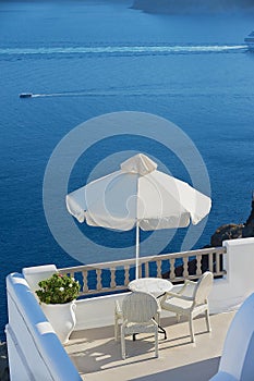 Two chairs with a sea view in Oia, Santorini island, Greece.