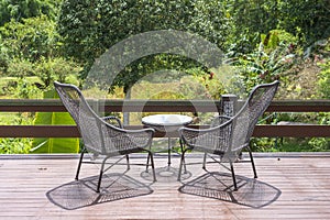 Two chairs and table on the backyard in tropical garden with beautiful view
