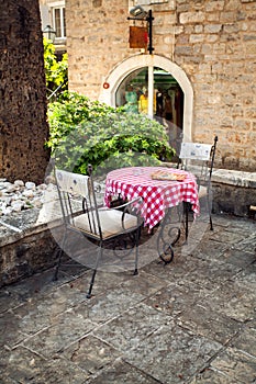 Two chairs and table on summer terrace of old restaurant