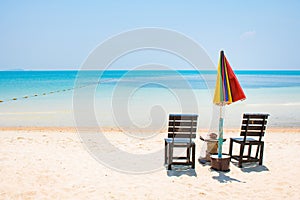 Two chairs with umbrela on white sand beach and blue sea in Same