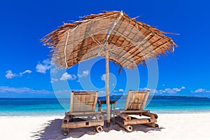 Two chairs and umbrella on beach