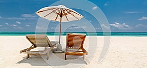 Two chairs and umbrella on idyllic beach on a tropical island, Maldives