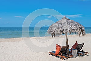 Two Chairs Under Parasol In Tropical Beach