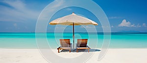 Two chairs under umbrella in tropical beach with a beautiful ocean view.