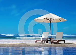 Two Chairs with White Umbrella at Beach