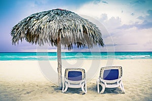 Two chaise lounges on the beach