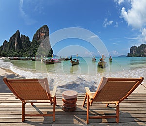 Two chaise lounges and the table on a wooden scaffold