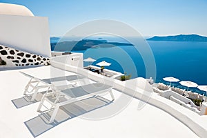 Two chaise lounges on the terrace. Santorini island, Greece