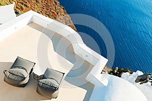 Two chaise lounges on the terrace with sea view.