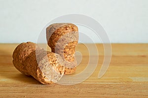 Two champagne corks on a wooden table. Close-up. Macro.