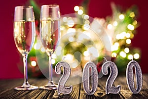 New Year decoration. Two gobelts with champagne with Christmas or New Year 2020 decoration on red light background