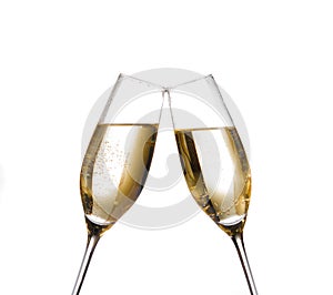 Two champagne flutes with golden bubbles make cheers on white background photo