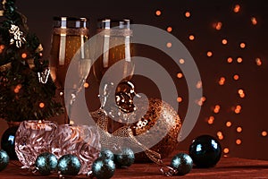 Two champagne glass on christmas bokeh background. New Year holiday decorated table.