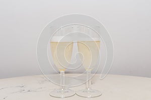 Two champagne glass foam on a table for valentine or honeymoon concept.Indoors shot