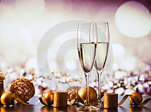 two champagne glasses against holiday lights and fireworks - new year celebration