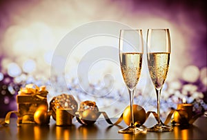 two champagne glasses against holiday lights and fireworks - new year celebration