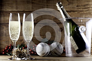 Two champagne glasses with champagne bottle and ice bucket