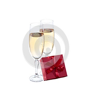Two champagne glasses and gift on white background