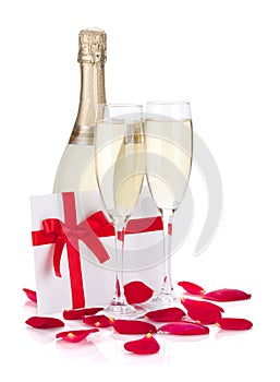 Two champagne glasses, letter and rose petals