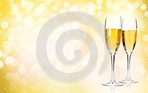 Two champagne glasses over christmas background