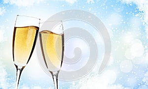 Two champagne glasses over christmas background