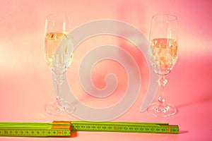 Two champagne glasses with a yardstick, symbolic of distance on New Year`s Eve, Happy New Year