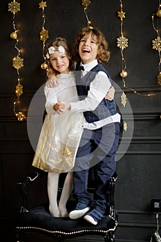 Two charming children stand having joined hands.