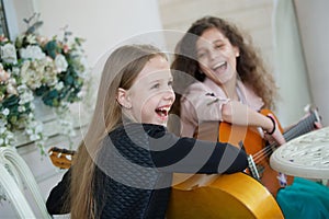 Two charming little girls with guitars