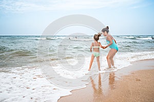 Two charming little girls in swimsuits